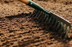 Raking topsoil - preparing to lay turf